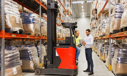 men with tablet pc and forklift at warehouse